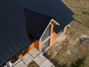 Modern wooden house featuring a sleek black roof in Okotoks